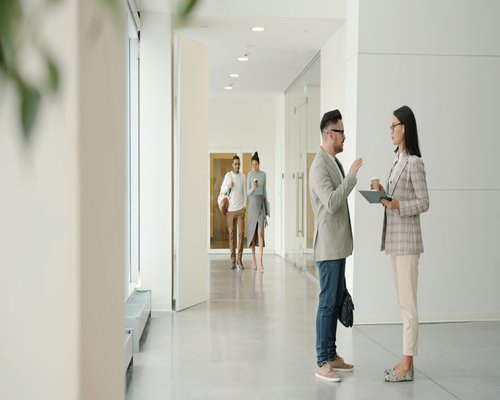Woman taking a short walking break in a modern office corridor